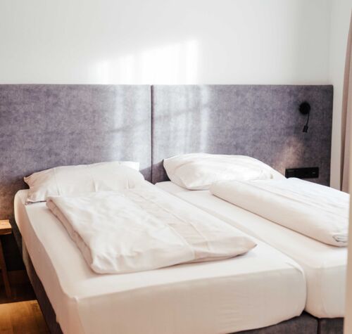 The freshly made double bed in the guest house double room at the 4-star Hotel Kirchbichl